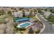Aerial view of community tennis courts and covered pool area surrounded by lush greenery and mature trees at 2032 W Nantucket Ct, Littleton, CO 80120