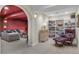 Inviting basement living area with book shelves, lounge chair, ottoman and sofa at 2032 W Nantucket Ct, Littleton, CO 80120