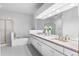 Bright bathroom featuring black and white tile, double sinks, and a glass shower and tub at 2032 W Nantucket Ct, Littleton, CO 80120
