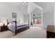 Spacious bedroom with vaulted ceiling, large window with view, a four-poster bed, and carpeted floor at 2032 W Nantucket Ct, Littleton, CO 80120