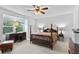 Carpeted bedroom with four-poster bed and large window at 2032 W Nantucket Ct, Littleton, CO 80120