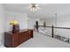Large, carpeted loft space with desk and railing at 2032 W Nantucket Ct, Littleton, CO 80120
