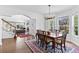Elegant dining room with hardwood floors, access to the living room, and a classic chandelier over the table at 2032 W Nantucket Ct, Littleton, CO 80120