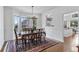 Bright dining room featuring a chandelier, a bay window, and a classic wood table with seating for six at 2032 W Nantucket Ct, Littleton, CO 80120