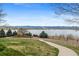Scenic exterior view with walking path, lake and mountain views at 2032 W Nantucket Ct, Littleton, CO 80120
