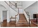 Grand foyer with hardwood floors and a beautiful staircase with white railings at 2032 W Nantucket Ct, Littleton, CO 80120