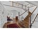 Open foyer featuring hardwood floors, staircase, and entry to the dining room at 2032 W Nantucket Ct, Littleton, CO 80120