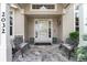 Welcoming front porch with seating, decorative plants, and stone flooring at 2032 W Nantucket Ct, Littleton, CO 80120