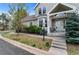 Inviting front entrance with bay window, lush landscaping, and a stone walkway at 2032 W Nantucket Ct, Littleton, CO 80120
