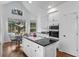 Bright kitchen offers an island cooktop, double ovens, and a breakfast nook with views of the landscaped backyard at 2032 W Nantucket Ct, Littleton, CO 80120
