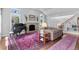 Spacious living room with a stone fireplace, piano, and hardwood floors at 2032 W Nantucket Ct, Littleton, CO 80120