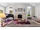 Cozy living room with a stone fireplace, piano, and plenty of natural light at 2032 W Nantucket Ct, Littleton, CO 80120