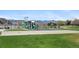 Gathering-friendly playground with slides, climbing structures and open play area at 2032 W Nantucket Ct, Littleton, CO 80120