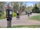 Scenic walking path with cyclists and pedestrians enjoying the High Line Canal in a natural park setting at 2032 W Nantucket Ct, Littleton, CO 80120