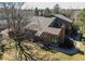 Overhead view featuring home's brick accents, mature trees, and inviting entrance framed by landscaped yard at 8109 E Phillips Cir, Centennial, CO 80112