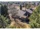 Aesthetic aerial view of a home in a mature and lushly vegetated neighborhood during late fall or early spring at 8109 E Phillips Cir, Centennial, CO 80112