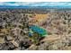 Scenic aerial shot showcasing community tennis courts, green spaces, and mountain views in a desirable neighborhood at 8109 E Phillips Cir, Centennial, CO 80112