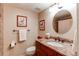 Bathroom featuring granite countertops, a round mirror, and decorative paintings at 8109 E Phillips Cir, Centennial, CO 80112