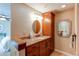 Bathroom featuring granite counters and wood cabinets, offering both functionality and elegance at 8109 E Phillips Cir, Centennial, CO 80112