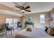 Serene bedroom with ceiling fan, a cozy seating area, and large windows, creating a relaxing ambiance at 8109 E Phillips Cir, Centennial, CO 80112