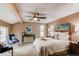 Comfortable bedroom with ceiling fan, plush bedding, and a view from the window, designed for rest at 8109 E Phillips Cir, Centennial, CO 80112