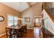 Well-lit dining room with a polished table setting next to the staircase and hardwood floors throughout the room at 8109 E Phillips Cir, Centennial, CO 80112