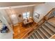 Bright dining area with hardwood floors, large windows, and an elegant chandelier with stairs adjacent at 8109 E Phillips Cir, Centennial, CO 80112