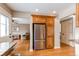 Kitchen view showing stainless steel refrigerator with custom wooden cabinets at 8109 E Phillips Cir, Centennial, CO 80112