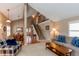 Bright living room with staircase and dining area, featuring a cozy atmosphere and seamless transition to entertaining at 8109 E Phillips Cir, Centennial, CO 80112