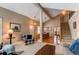 Open-concept living room with staircase, leading into dining area, creating a bright and welcoming atmosphere at 8109 E Phillips Cir, Centennial, CO 80112