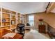 Well-lit office space featuring built-in shelving, a comfortable chair, and a view from the window at 8109 E Phillips Cir, Centennial, CO 80112