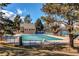 Community pool, covered for the winter, with tennis courts nearby at 8109 E Phillips Cir, Centennial, CO 80112