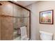 Tiled shower featuring a glass door and modern fixtures, providing a spa-like experience at 8109 E Phillips Cir, Centennial, CO 80112