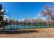 Outdoor tennis courts and basketball court surrounded by a black metal fence at 8109 E Phillips Cir, Centennial, CO 80112