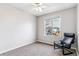 A carpeted bedroom with a black leather chair by the window at 16510 Buckthorn Ln, Parker, CO 80134