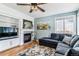 Cozy living room featuring a fireplace, built-in shelving, and a comfortable seating area at 16510 Buckthorn Ln, Parker, CO 80134