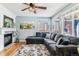 Inviting living room with a fireplace, plush sectional, and lots of natural light at 16510 Buckthorn Ln, Parker, CO 80134