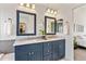 Bathroom with double sinks, modern lighting, and decorative mirrors at 2090 Bellavista St, Castle Rock, CO 80109