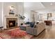 Bright living room features hardwood floors, fireplace, and flows into the modern kitchen at 2090 Bellavista St, Castle Rock, CO 80109