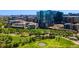 Expansive green park area surrounded by modern apartment buildings and lush trees at 1700 Bassett St # 1014, Denver, CO 80202