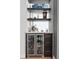 Stylish bar area with a wine fridge, floating shelves, and elegant countertop at 1700 Bassett St # 1014, Denver, CO 80202
