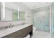 Modern bathroom featuring a double vanity, marble countertops, and a glass-enclosed shower at 1700 Bassett St # 1014, Denver, CO 80202