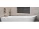 Close-up of a modern white bathtub with stylish fixtures and a decorative tile niche at 1700 Bassett St # 1014, Denver, CO 80202
