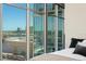 Bedroom view showcasing floor-to-ceiling windows and expansive city views at 1700 Bassett St # 1014, Denver, CO 80202