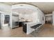 Open kitchen featuring an island with bar stools, stainless steel appliances, and hardwood floors at 1700 Bassett St # 1014, Denver, CO 80202