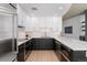 Modern kitchen featuring two-tone cabinets, stainless steel appliances, and hardwood floors at 1700 Bassett St # 1014, Denver, CO 80202