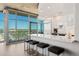 Open-concept kitchen with bar seating, stainless steel appliances, and city views at 1700 Bassett St # 1014, Denver, CO 80202