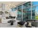 Stylish living room with city view, a modern chandelier, and concrete ceilings at 1700 Bassett St # 1014, Denver, CO 80202