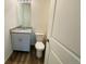 Bathroom with wood-look flooring, light gray vanity, and granite countertop at 45016 Sunflower Ln, Bennett, CO 80102