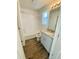 Bathroom with tub and shower combo, granite-topped vanity, and wood-look flooring at 45016 Sunflower Ln, Bennett, CO 80102